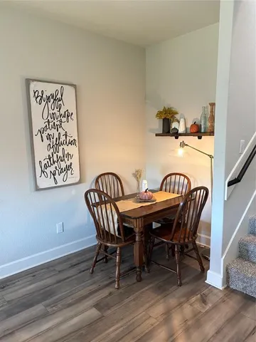 a view of a dining room with furniture and wooden floor
