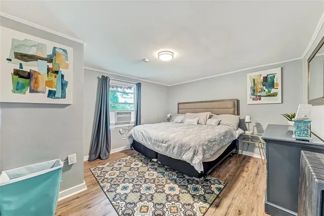 a bedroom with a bed and painting on the wall