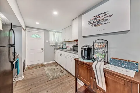 a kitchen with stainless steel appliances granite countertop a refrigerator sink and wooden floor