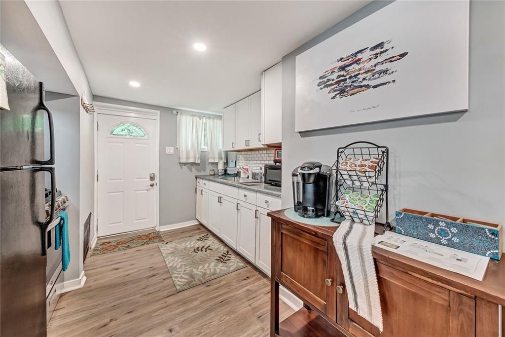 6206 Ira Way Pittsburgh, PA 15217 - Photo 14 of 36 a kitchen with stainless steel appliances granite countertop a refrigerator sink and wooden floor