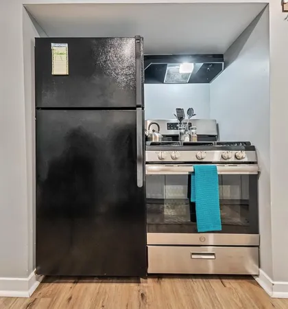 a kitchen with a refrigerator and a stove