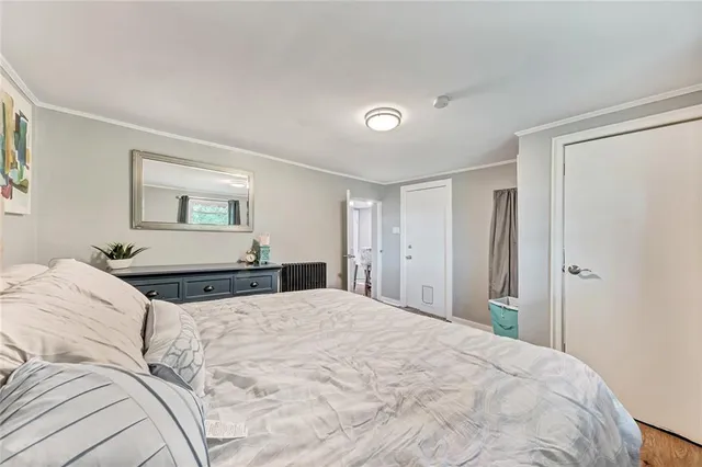 a bedroom with a large bed and a chandelier