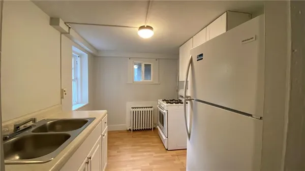 a kitchen with a sink and refrigerator