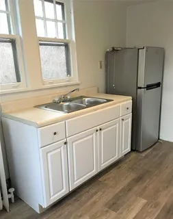 a utility room with cabinets washer and dryer
