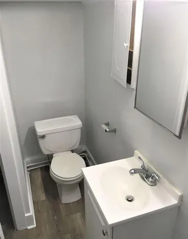 a white toilet sitting next to a bathroom sink