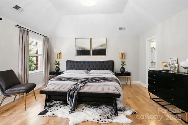 a bedroom with a bed and a dresser in it