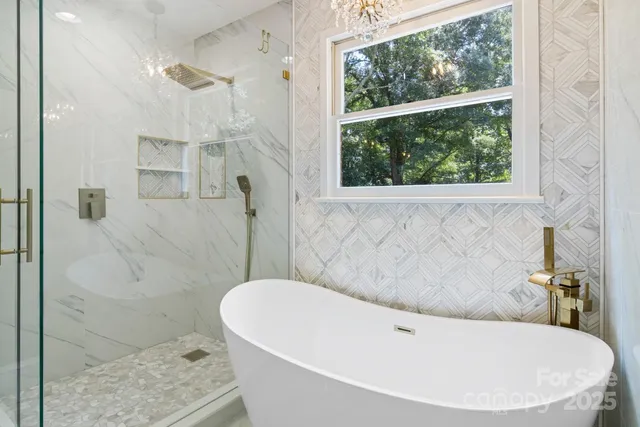a bathroom with a bathtub and shower