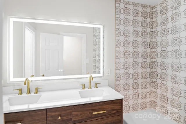 a bathroom with a sink a mirror and a shower