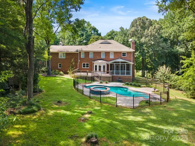 a swimming pool with outdoor seating and yard