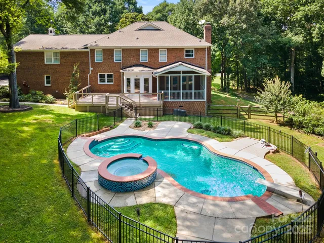 a aerial view of a house with swimming pool patio and outdoor seating
