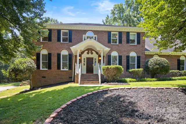 a front view of a house with garden and porch
