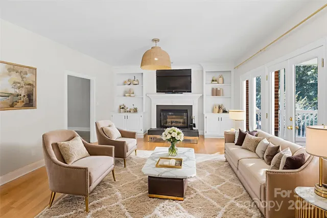 a living room with furniture a fireplace and a flat screen tv