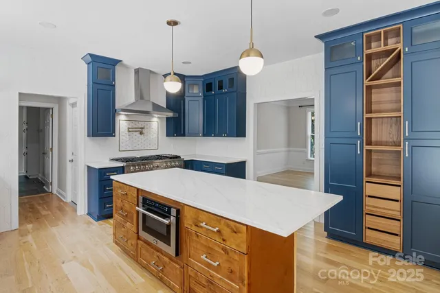a kitchen that has a cabinets and steel stainless steel appliances