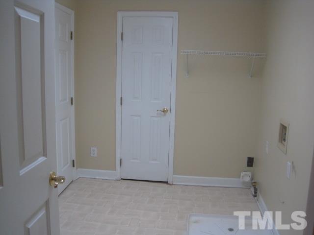 1336 Turner Farms Road Garner, NC 27529 - Photo 15 of 22 Large laundry room with access door to walk-in attic space.