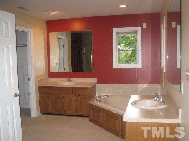 1336 Turner Farms Road Garner, NC 27529 - Photo 19 of 22 Has whirlpool tub, separate shower, separate vanities, room with toilet and walk-in closet.