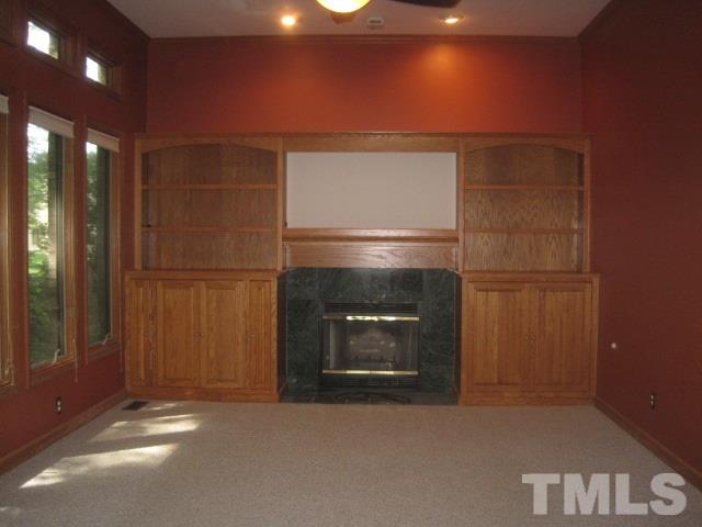 1336 Turner Farms Road Garner, NC 27529 - Photo 9 of 22 Carpeting, fireplace, built-in bookcases and recessed lighting.