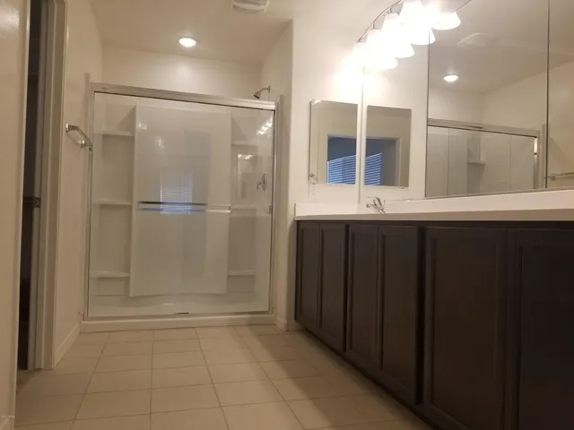 a bathroom with a shower and a sink