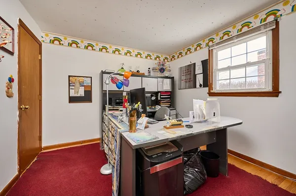 a utility room with stainless steel appliances a sink dishwasher a microwave oven and a dining table with wooden floor