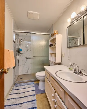 a bathroom with a sink toilet and shower