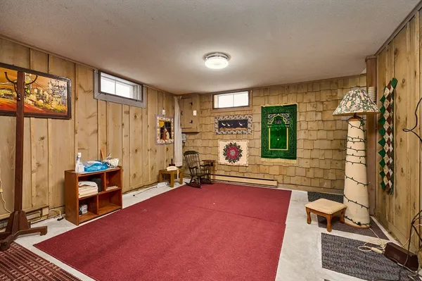 a living room with furniture a flat screen tv and large window