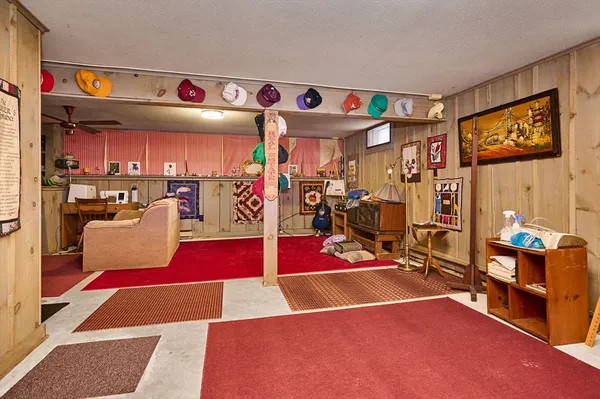 a living room with furniture a flat screen tv and a wall painting