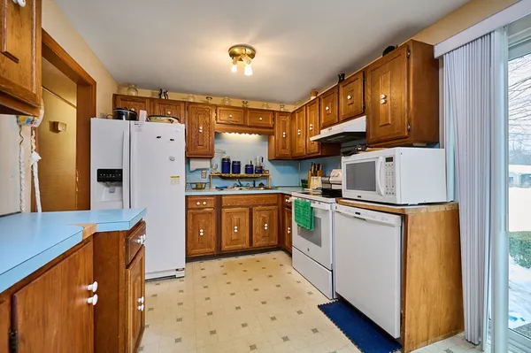 a kitchen with stainless steel appliances a refrigerator and a stove top oven