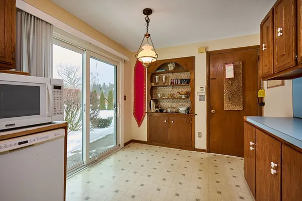 a bedroom with a bed and a flat tv screen on dresser