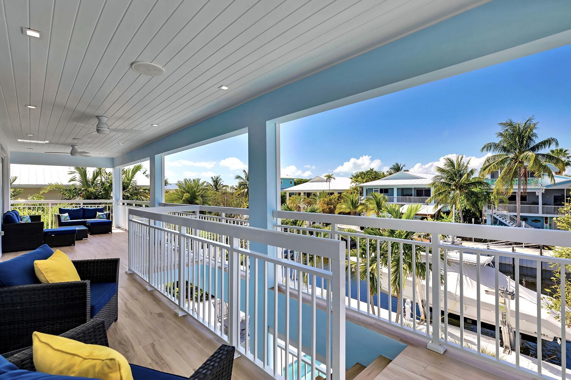121 Lake Road Tavernier, FL 33070 - Photo 13 of 51 a view of a chairs and tables in the balcony