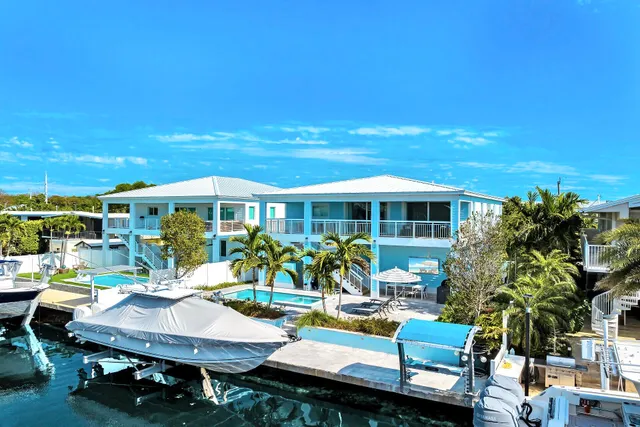 a view of a patio with table and chairs and potted plants