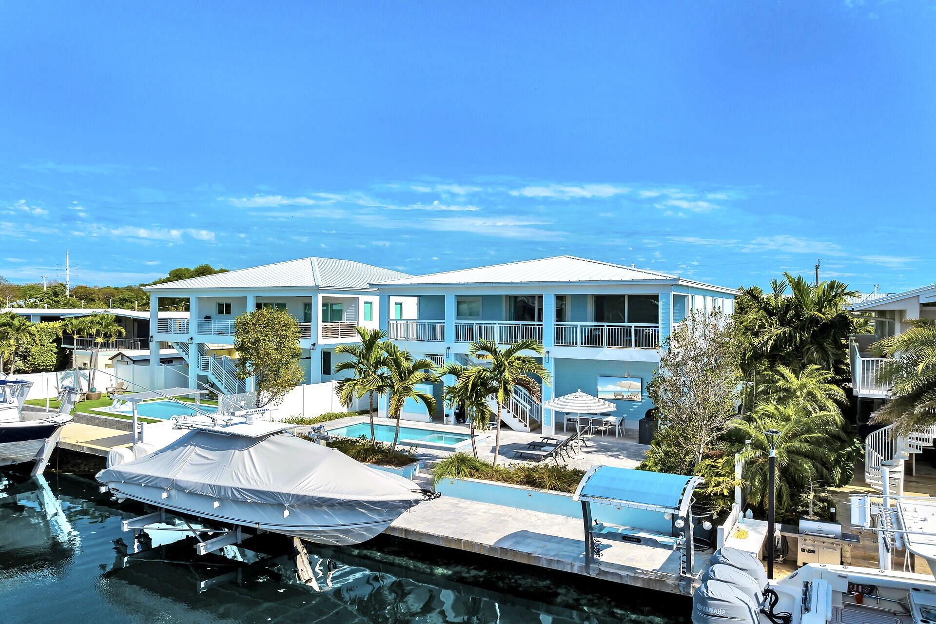 121 Lake Road Tavernier, FL 33070 - Photo 2 of 51 a view of a patio with table and chairs and potted plants