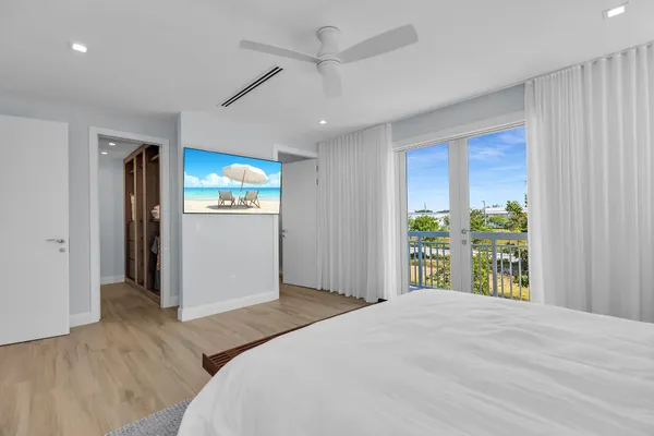 a bedroom with two beds and a wooden floor