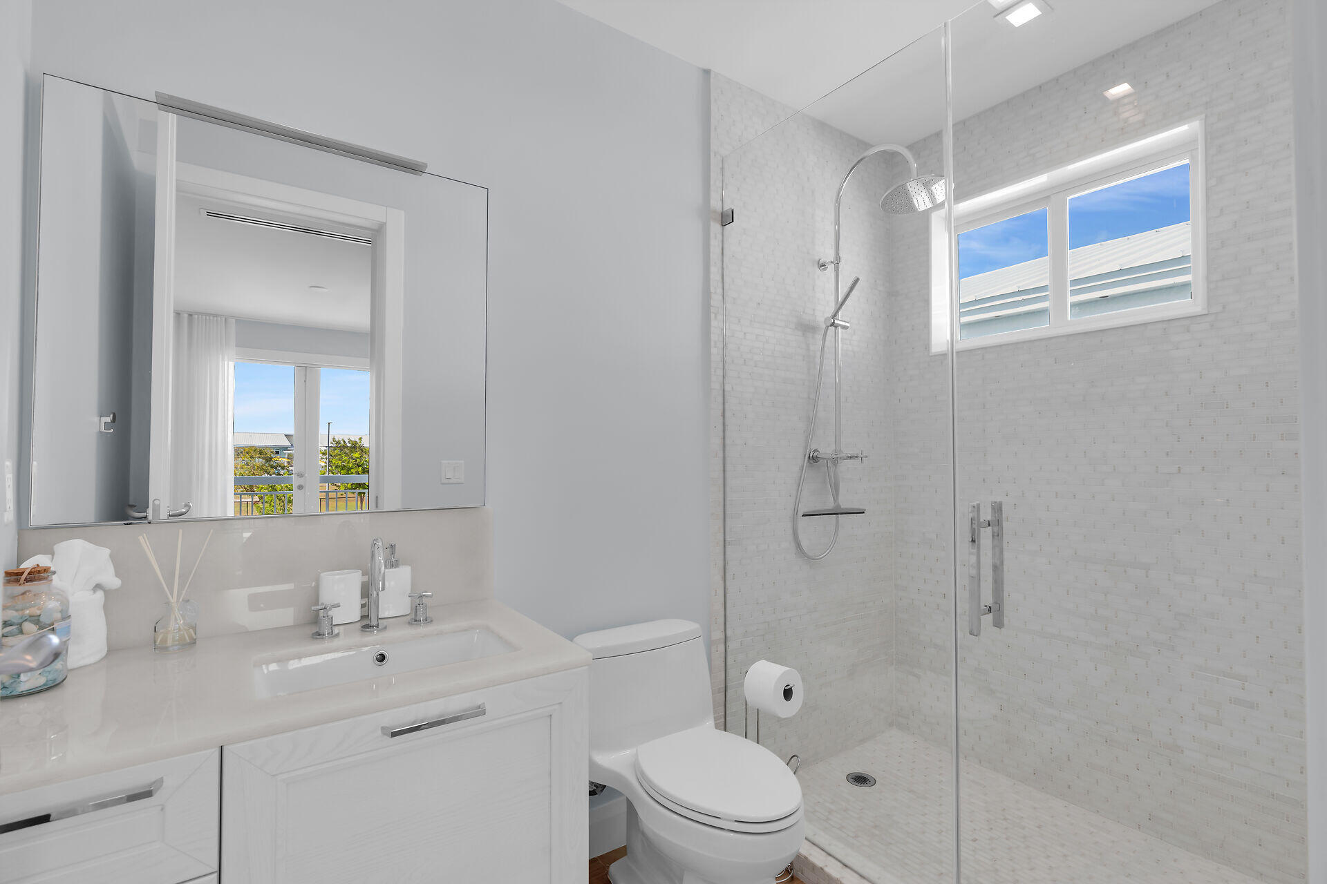 121 Lake Road Tavernier, FL 33070 - Photo 33 of 70 a bathroom with a toilet a sink a mirror a shower and vanity