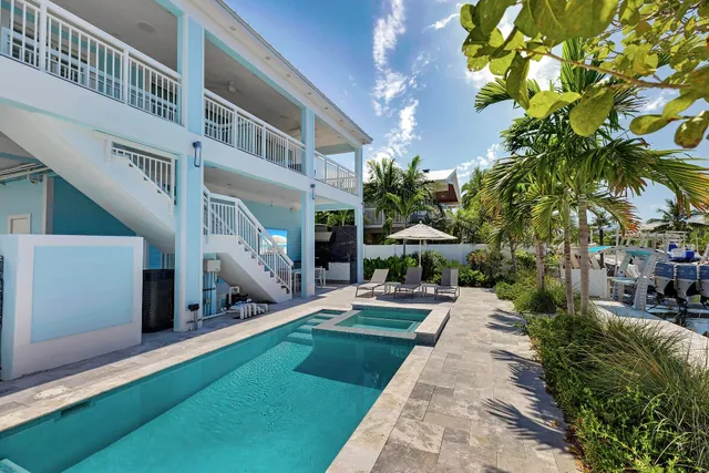 a view of yard with swimming pool and furniture