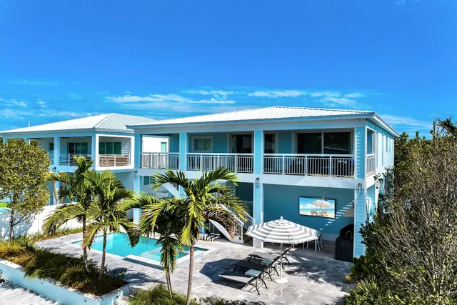 a view of house with yard outdoor seating and lake view