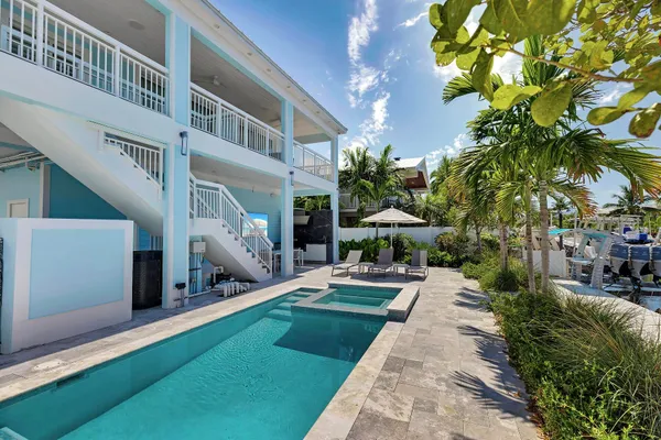 a view of house with yard outdoor seating and lake view