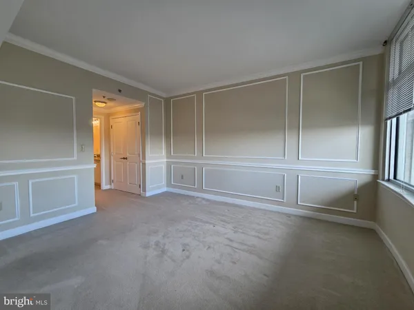 an empty room with window and closet