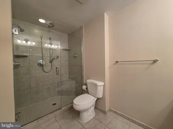 a bathroom with a toilet and a shower