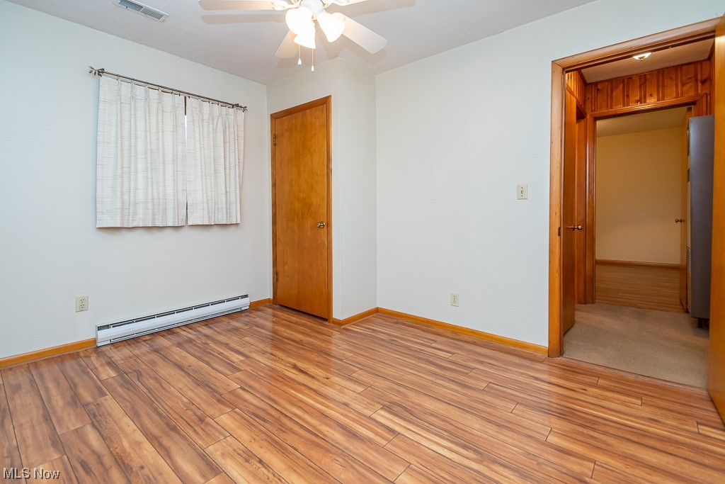 5 Pleasantview Vermilion, OH 44089 - Photo 19 of 37 Spare room with ceiling fan, baseboard heating, and light wood-type flooring