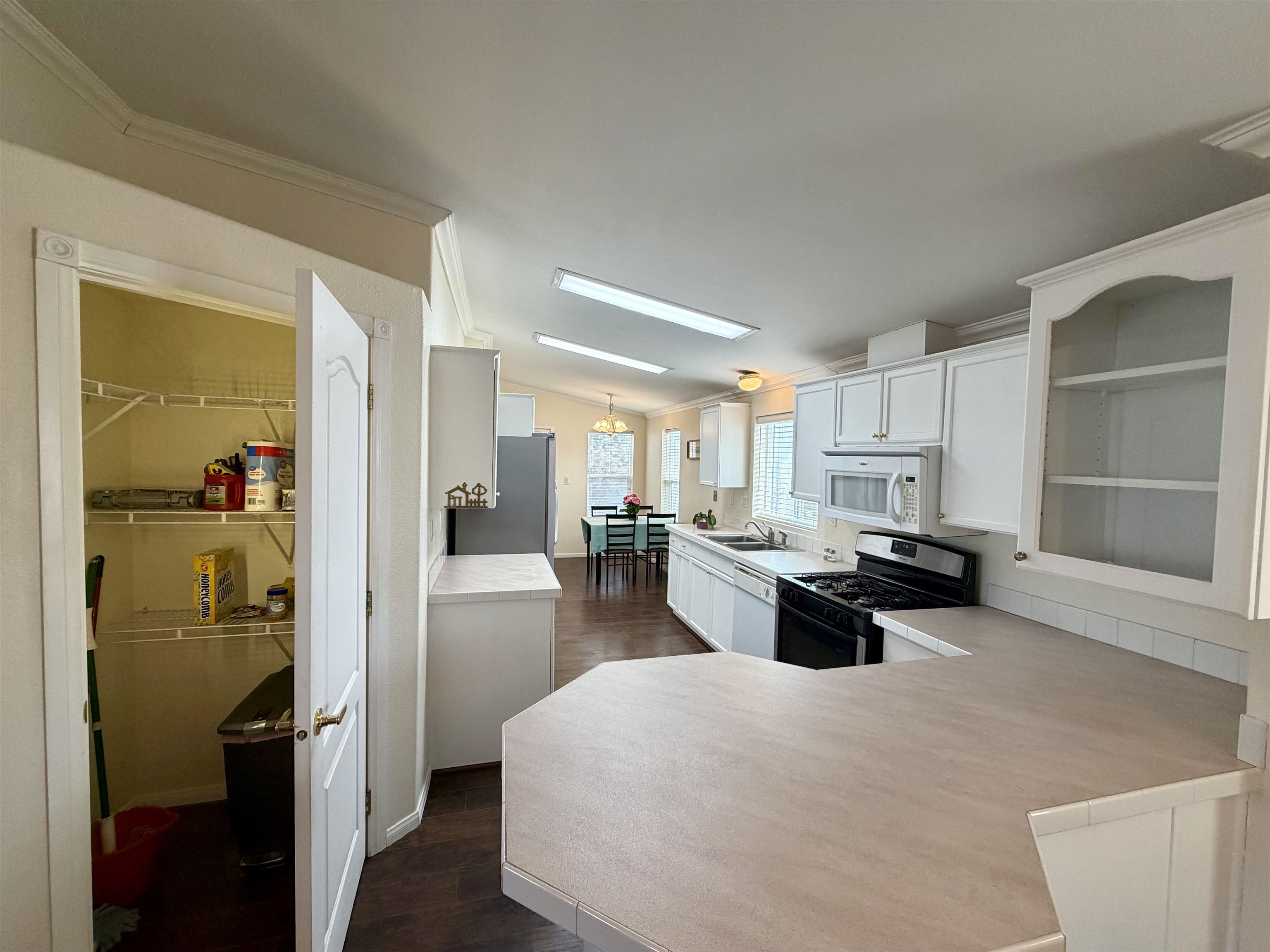 435 32 Road, Unit 480 Clifton, CO 81520 - Photo 9 of 23 a kitchen view with a refrigerator and a counter top space