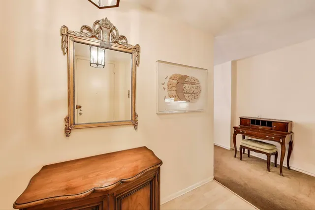 a kitchen with granite countertop a refrigerator a stove a dining table and chairs with wooden floor