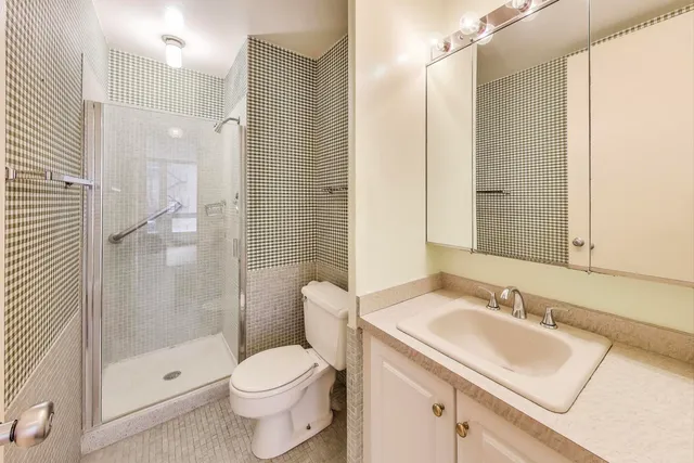a bathroom with a sink a mirror and a shower