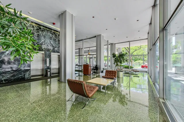 a living room with patio furniture and a potted plant