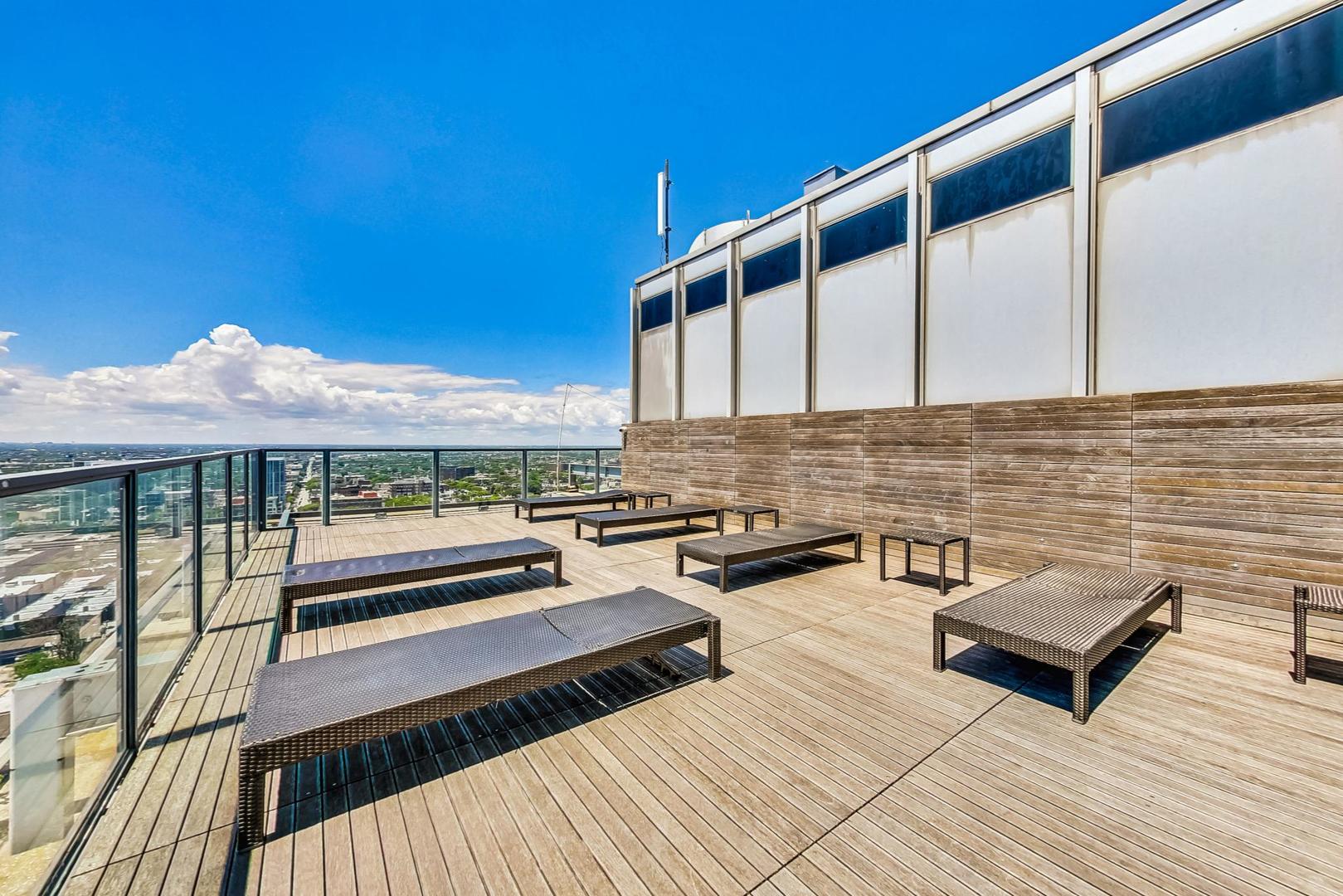 2400 North Lakeview Avenue, Unit 1708 Chicago, IL 60614 - Photo 31 of 50 a view of a balcony with chairs and wooden floor