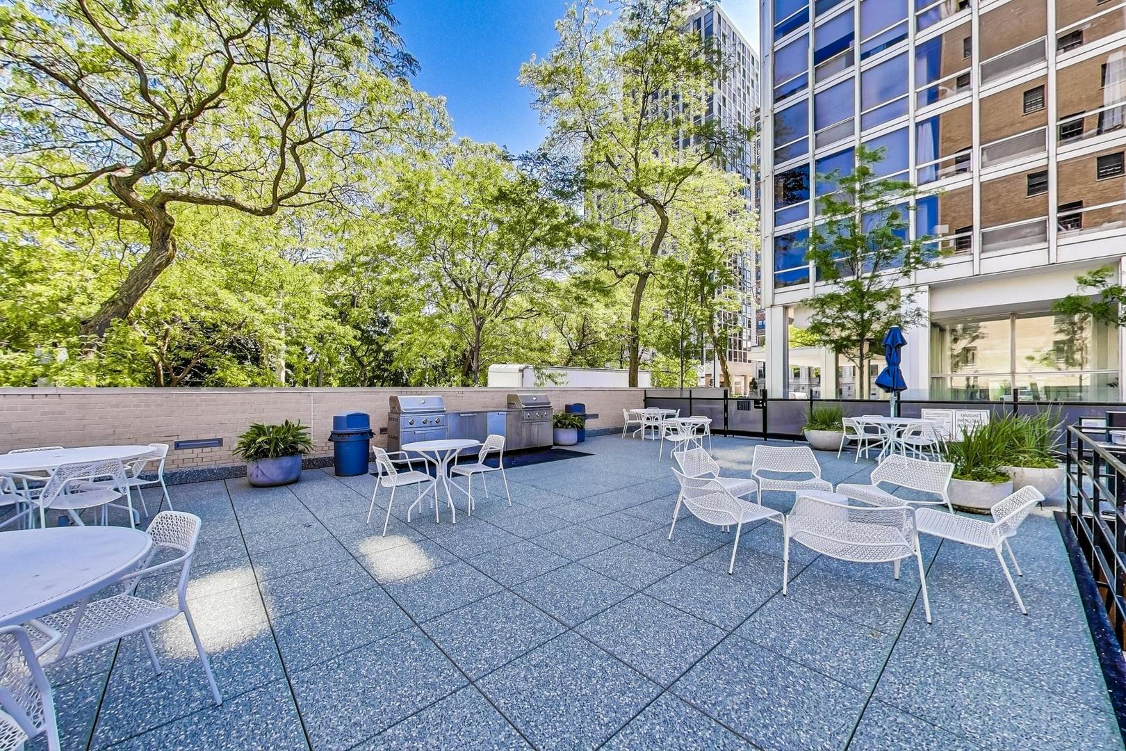 2400 North Lakeview Avenue, Unit 1708 Chicago, IL 60614 - Photo 40 of 50 a view of a patio with a table and chairs and couches