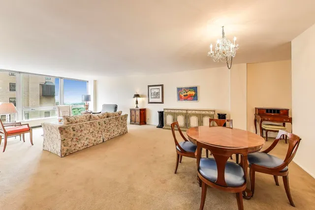 a living room with furniture and a chandelier