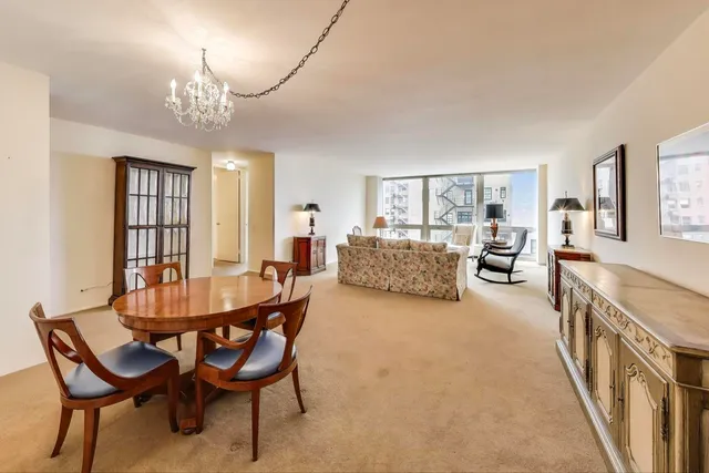 a living room with furniture and a chandelier