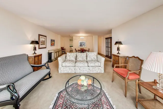 a living room with furniture and a lamp