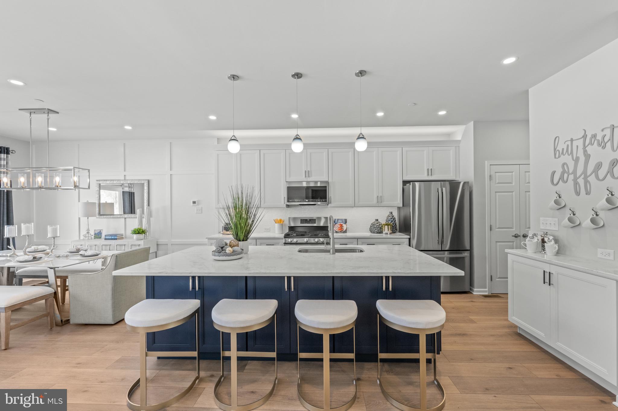 156 Bancroft Road, Unit CARLTON Kennett Square, PA 19348 - Photo 1 of 47 a kitchen with stainless steel appliances granite countertop a kitchen island and chairs in it