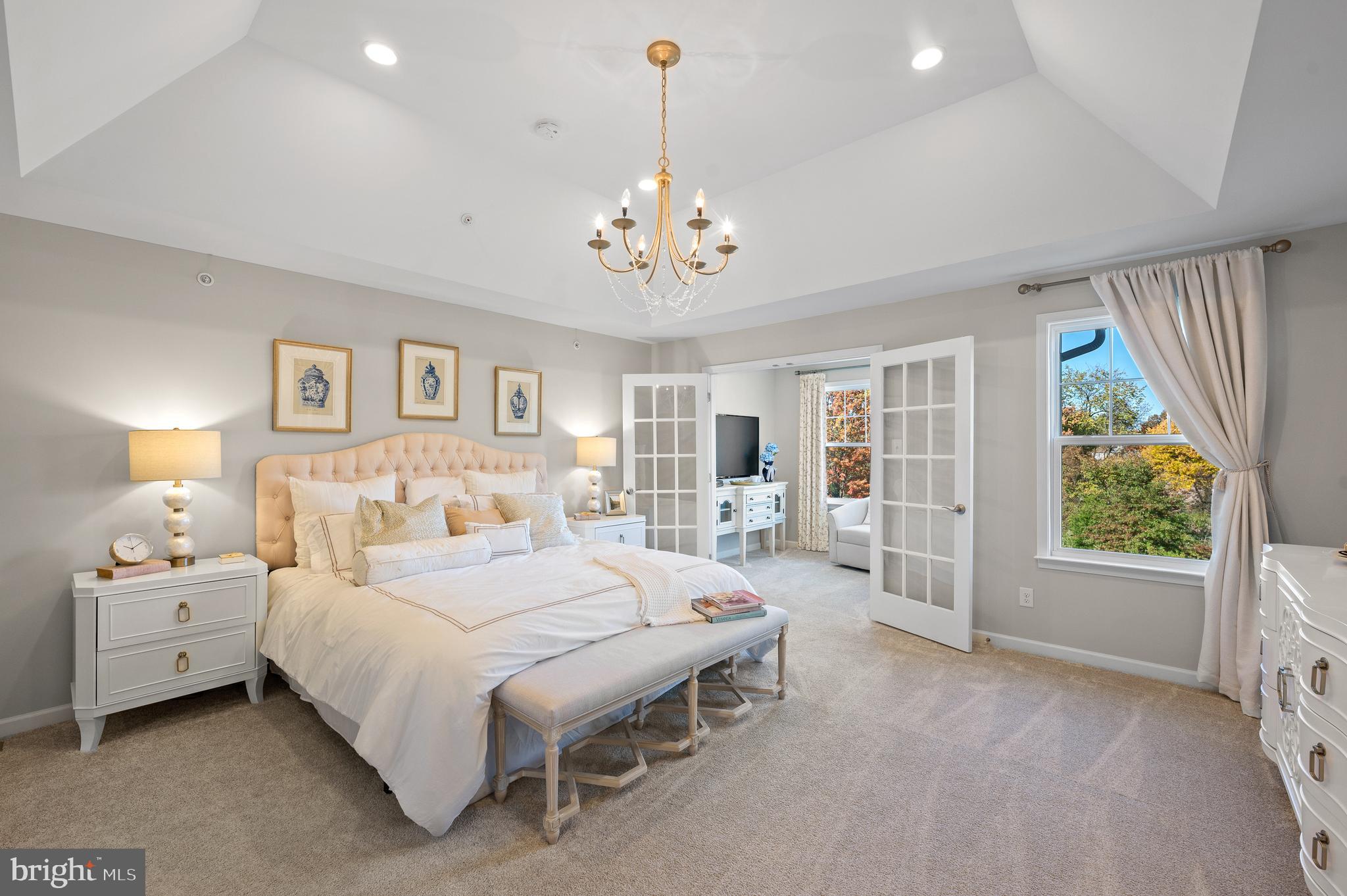 156 Bancroft Road, Unit CARLTON Kennett Square, PA 19348 - Photo 12 of 46 a bedroom with a large bed and a chandelier