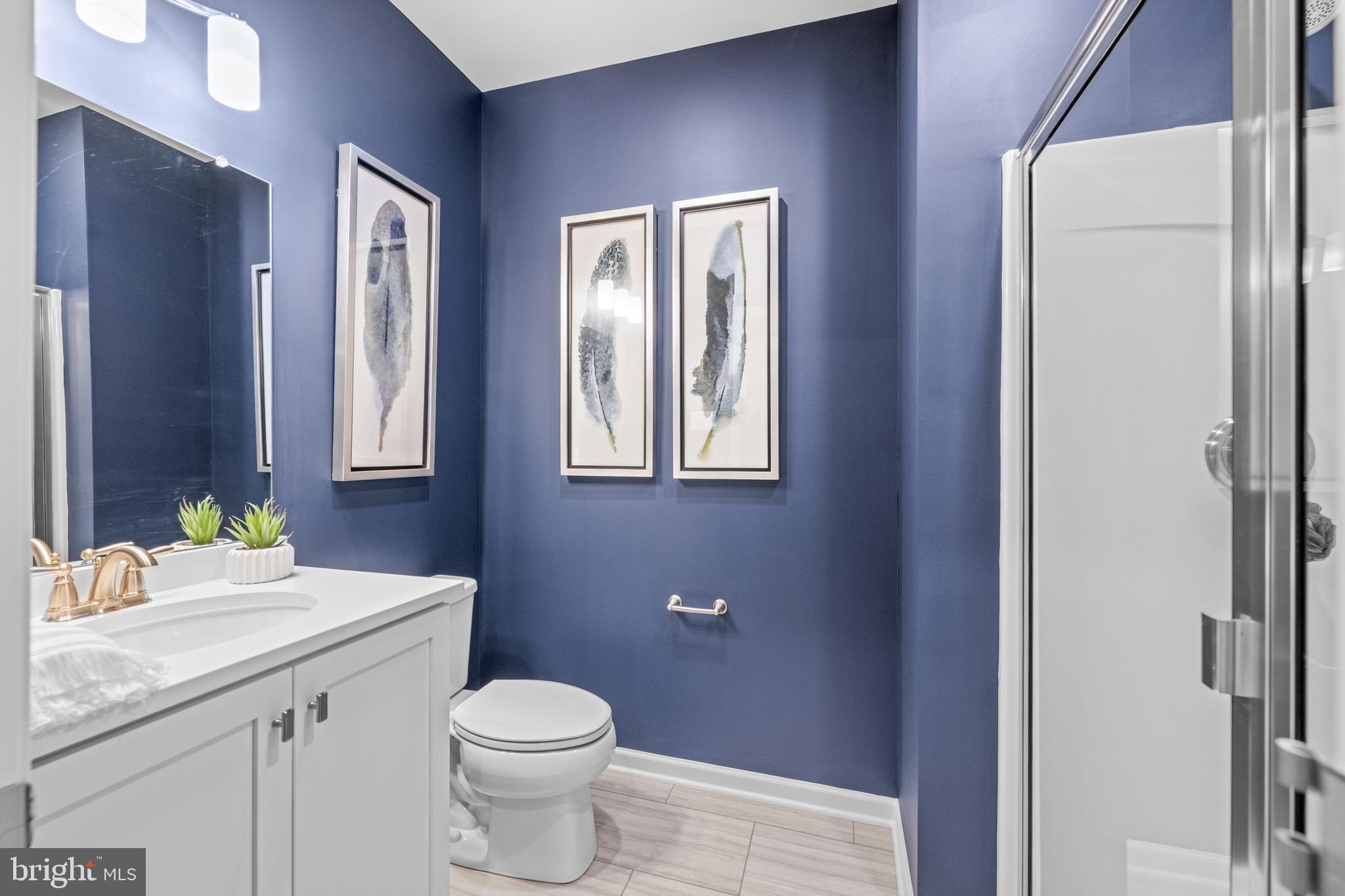 156 Bancroft Road, Unit CARLTON Kennett Square, PA 19348 - Photo 26 of 47 a bathroom with a granite countertop toilet sink and mirror